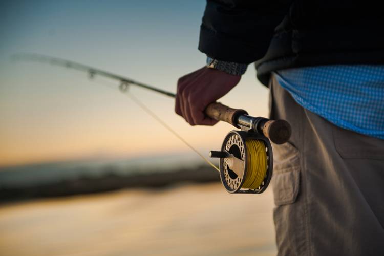 A man holds a fishing pole