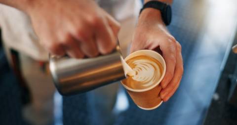 A person pouring coffee at a shop in Port Aransas.