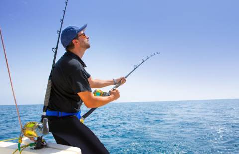 Deep Sea Fishing Texas A man deep sea fishing in Texas off the shores of Port Aransas.