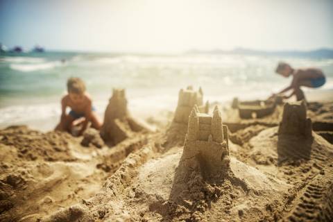 Children build a sandcastle at a Port A beach Children build a sandcastle at a Port A beach