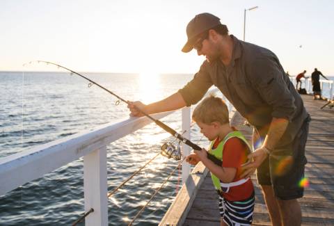 A father teaching his son to fish A father teaching his son to fish