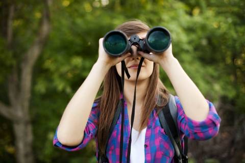 Things to Do in Port Aransas A woman birdwatching, one of the top things to do in Port Aransas.